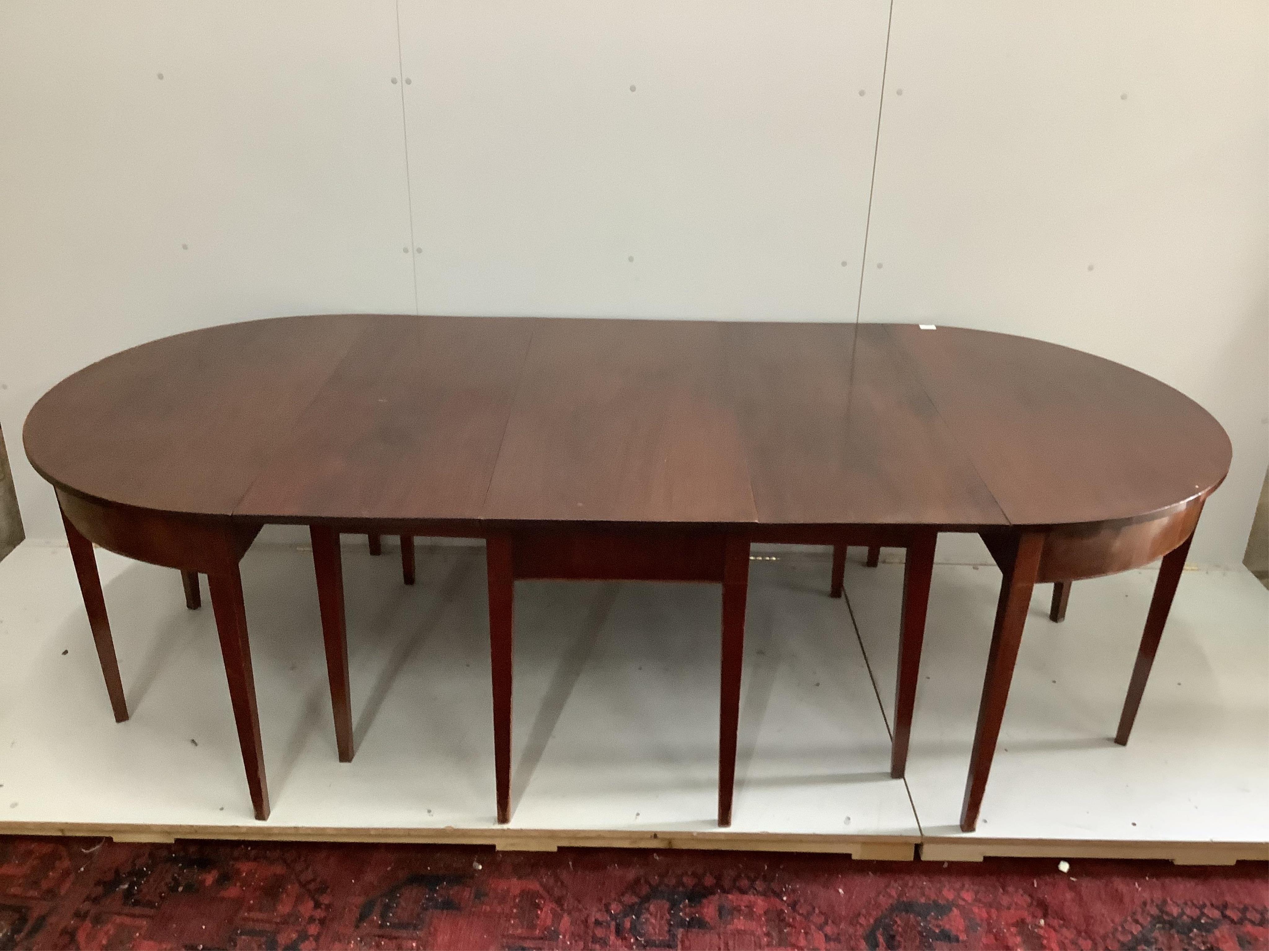 A George III mahogany D-end extending dining table, width 170cm, depth 120cm, height 73cm. Condition - fair